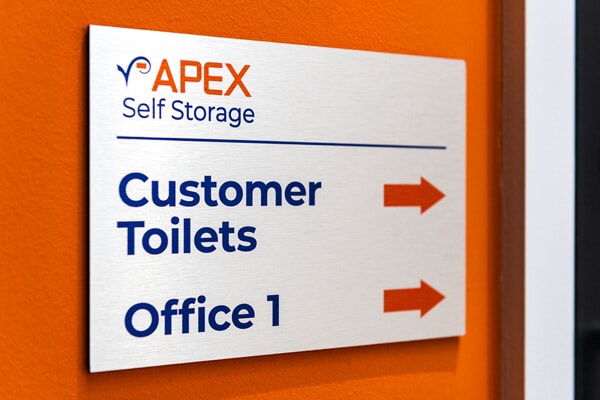An image of indoor wayfinding signage for bathrooms and office 1.